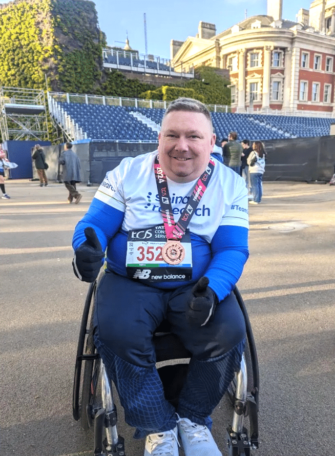 Photo of a Spinal Research fundraiser in a wheelchair during London Marathon.