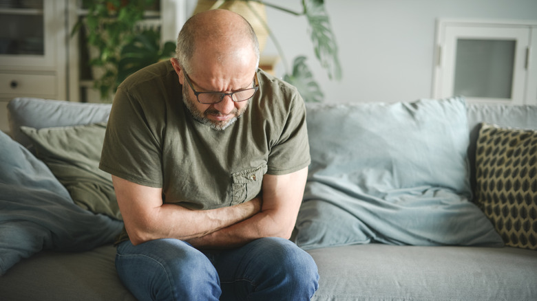 An older man feeling prostate discomfort