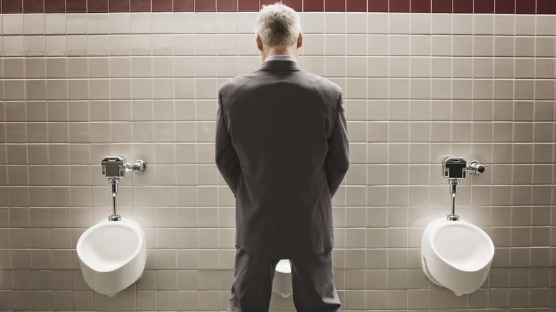 A man using a urinal