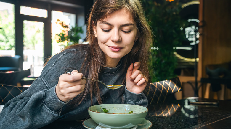 A woman eating a healthy bowl of food while