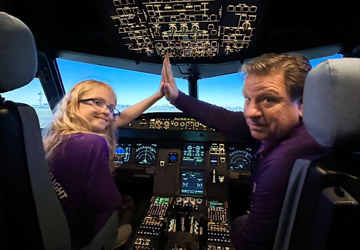 Avelo Airlines COO Greg Baden high-fives a participant in the airline's Aviation Career Exploration (ACE) program. 