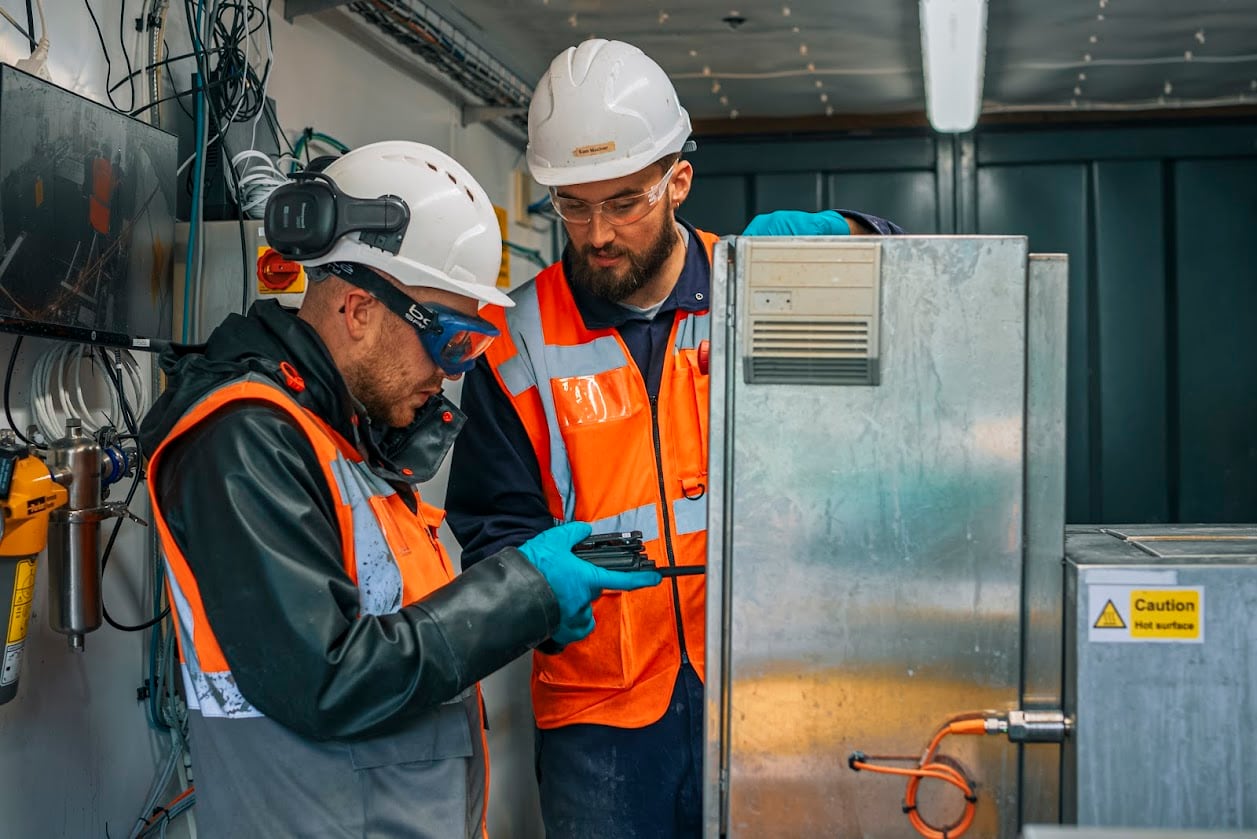 The MiAlgae team check the controls on the ground at its commercial demonstrator site.