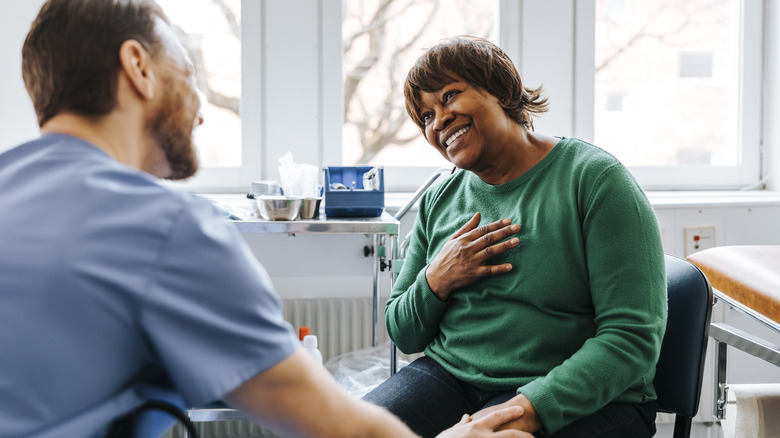 happy female patient receiving good news from doctor