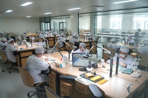 Watchmakers at work inside the Peacock Watch Company in Dandong, China, which produces 1.5 million mechanical movements per year.