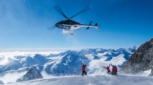 Helicopter over snow-capped mountains