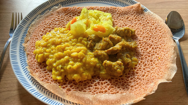 Injera bread topped with vegetables