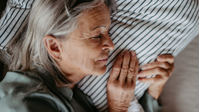 A senior woman sleeping on a pillow