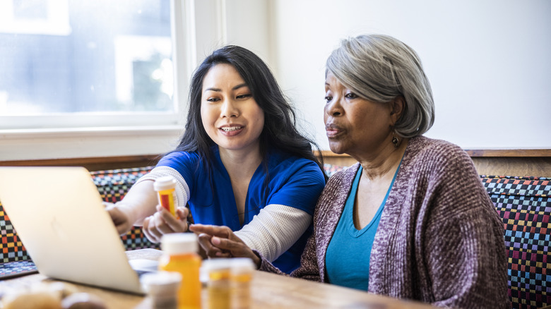 nurse teaching woman about her medications