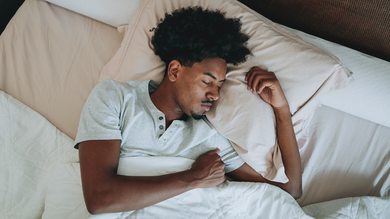 man sleeping in bed