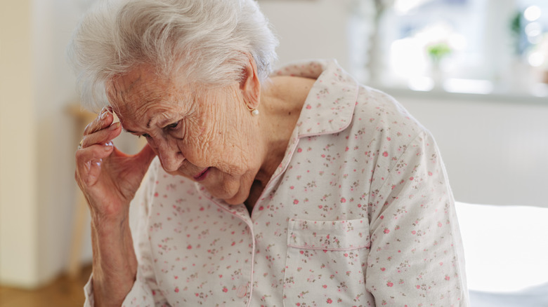 older woman with dementia looking down