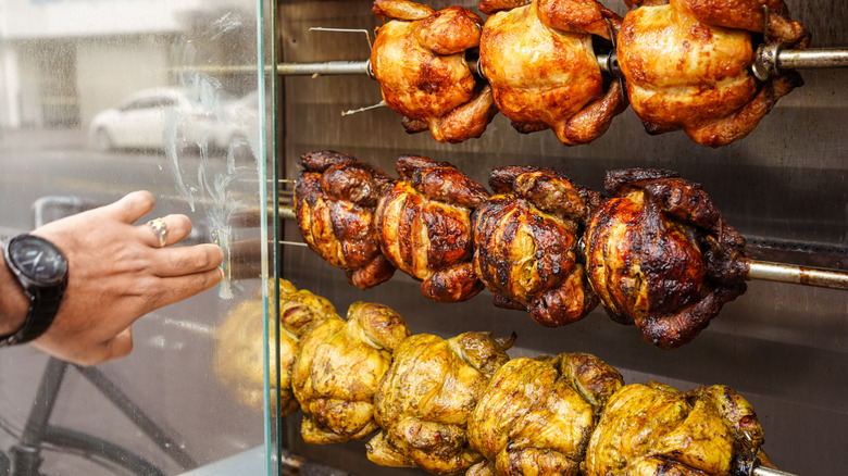 A man opening a case of rotisserie chickens